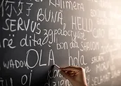 a hand writing on a chalkboard