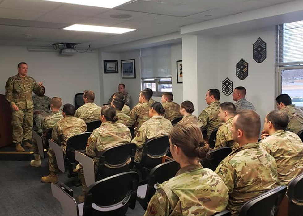 a group of people in military uniforms in a classroom