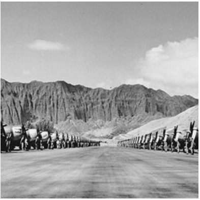 long shot of a line of cement mixers<br />
