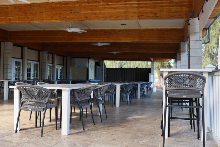 a patio with tables and chairs