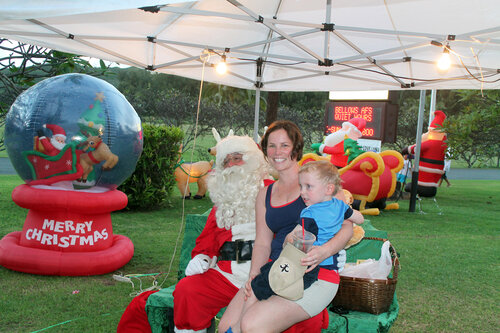 mother and son taking picture with santa