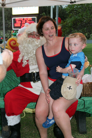 mom and son taking picture with santa