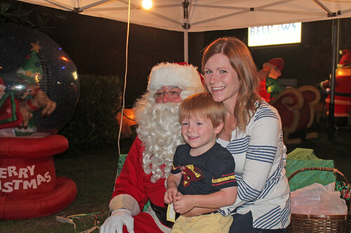 mother and son taking picture with santa