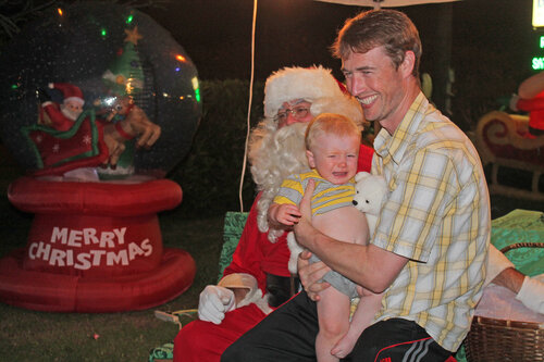 dad and son taking picture with santa