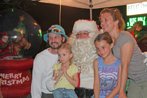 a family taking picture with santa