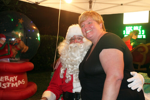 a lady taking picture with santa