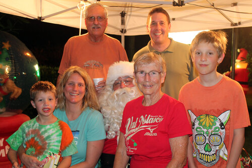 family taking picture with Santa