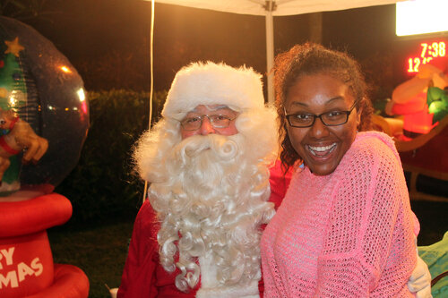 a lady taking a picture with santa