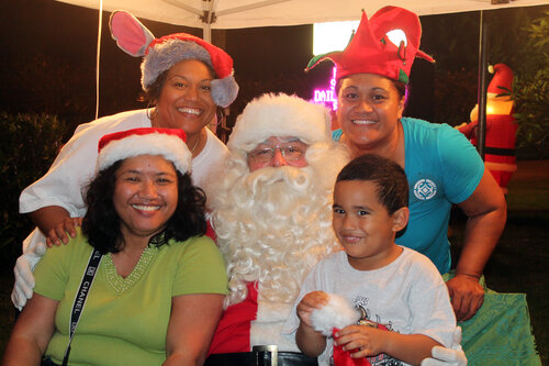 family taking a picture with santa