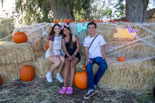  children in clothing sitting on hay bales<br />
