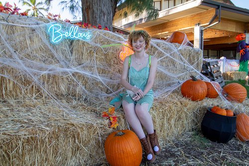 a lady in costumes sitting on hay bales<br />
