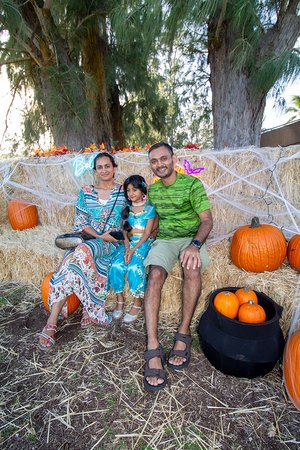 family in a garment sitting on hay