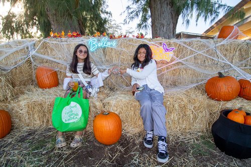 children in a garments sitting on hay