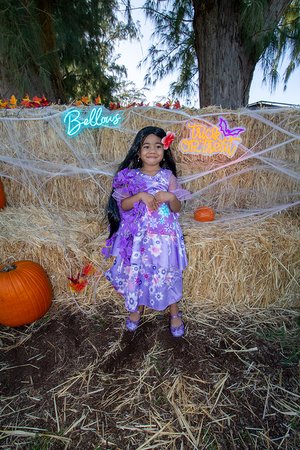 a kid in garment posing for picture in Halloween 