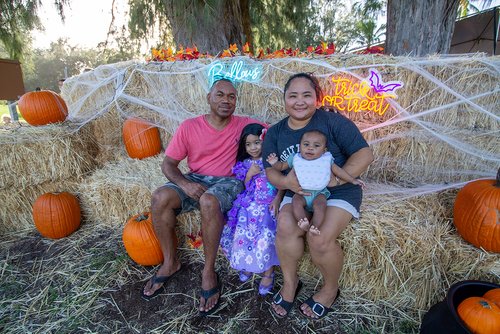 family clothing sitting on a hay bale<br />
