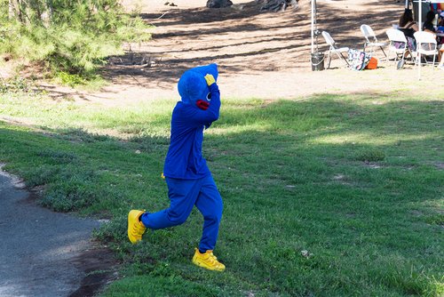 a person in blue suit and yellow shoes