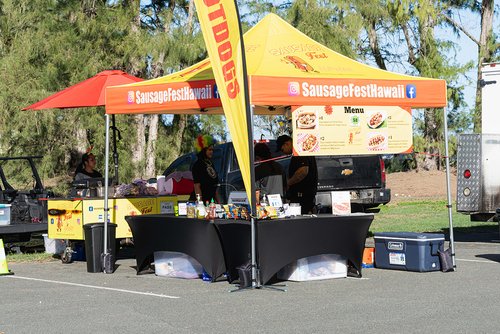 a food stand with a couple of people standing in front of it