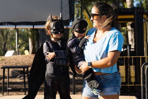 a person holding two children