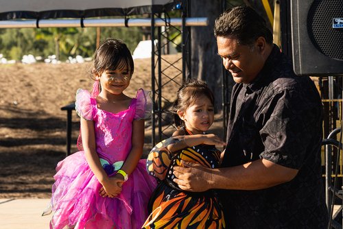 a person holding two children