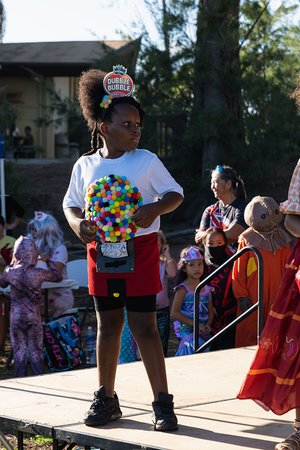 a child holding a bubble gum ball