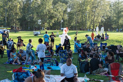 a group of people sitting on the grass<br />
