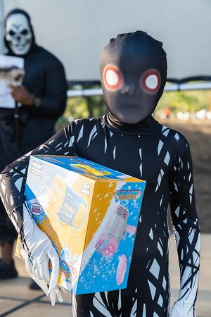 a child in garment holding a box