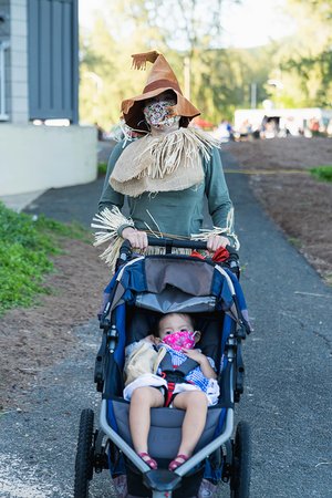 a person in a scarecrow garment pushing a stroller<br />
