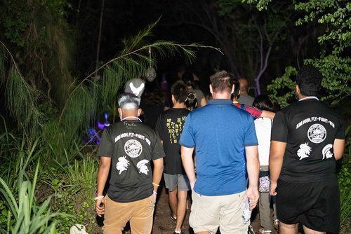 a group of people walking in a dark area<br />
