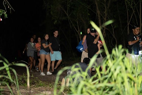 a group of people walking in a dark area<br />
