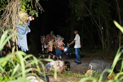 a group of people walking in a dark area<br />
