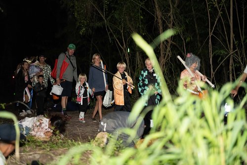 a group of people walking in a dark area<br />
