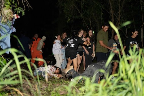 a group of people walking in a dark area<br />
