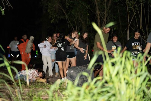 a group of people walking in a dark area<br />
