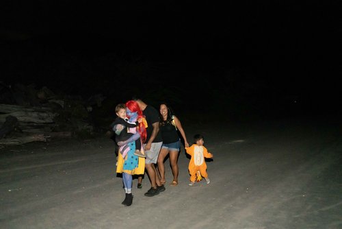 a group of people walking in a dark area