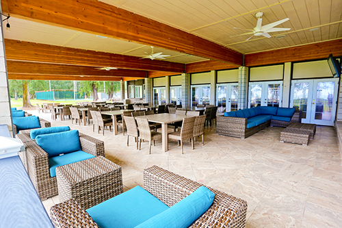 a patio with chairs and tables