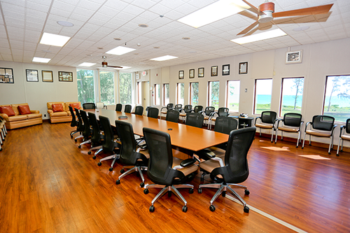 a conference room with a long table and chairs