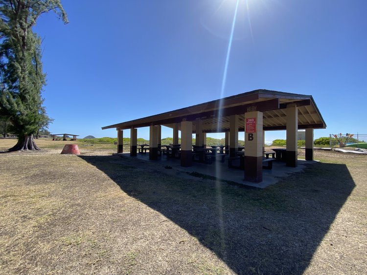 a picnic area with a covered roof