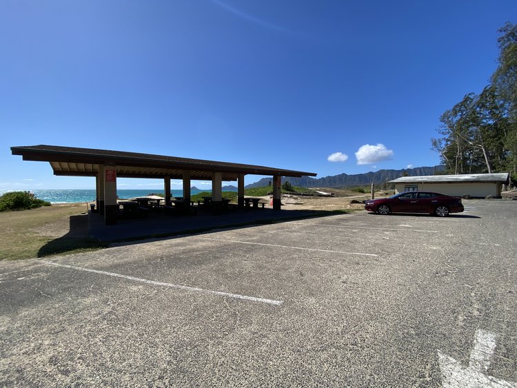 a parking lot with a building and a car parked in front of it