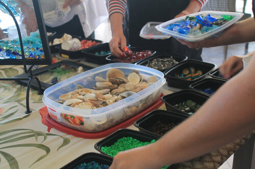 a group of people holding plastic containers with food