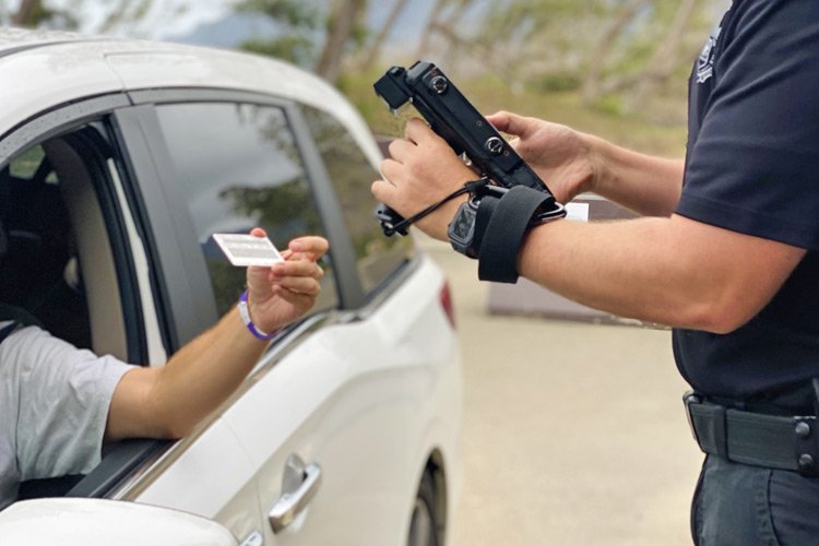 a person holding a gun and a card