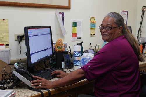 a person sitting at a desk using a computer