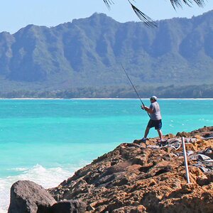 a man fishing in the ocean