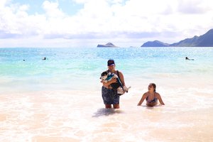 a lady with her dog at the beach