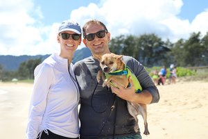 a person and person holding a dog on a beach<br />
