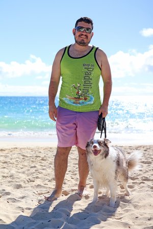 a person walking a dog on a beach<br />
