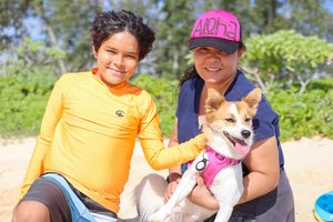 a lady and child holding a dog 