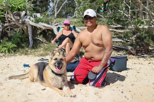 a person and person with a dog on a beach<br />
