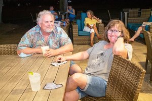 a man and a woman sitting at the table 