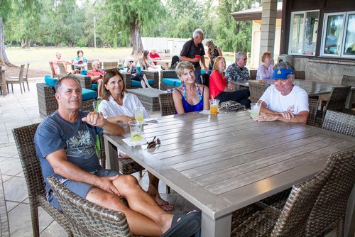 a group of people sitting around the table 