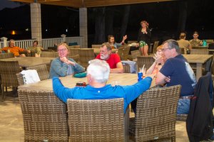 a group of people sitting around a table<br />
